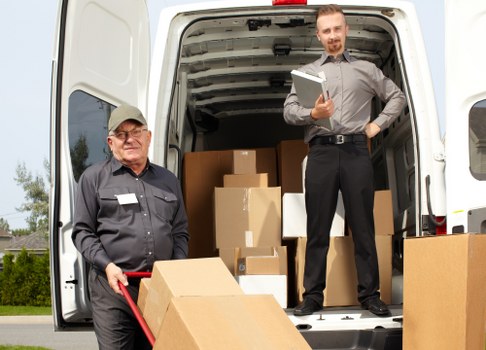 Professional man and van service loading furniture