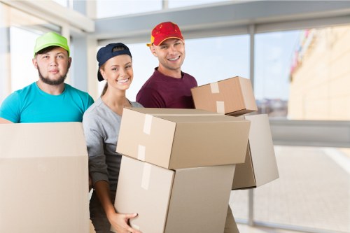 Professional movers packing boxes in a van