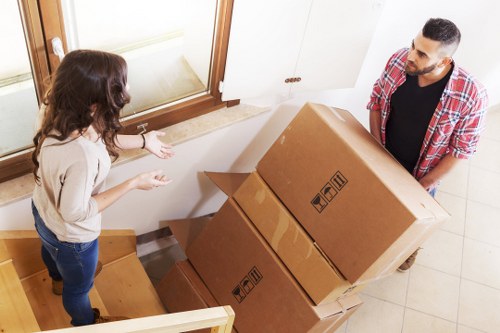 Two movers carrying a box carefully during a house removal
